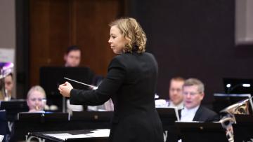 Katrina Marzella-Wheeler conducting a brass band